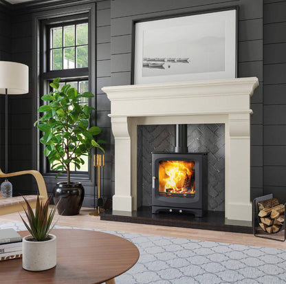 Bertoneri Ardmore Alpine White Surround with stove chamber and Black Granite Hearth, pictured with Henley Alderwood 6.7kW Freestanding Stove
