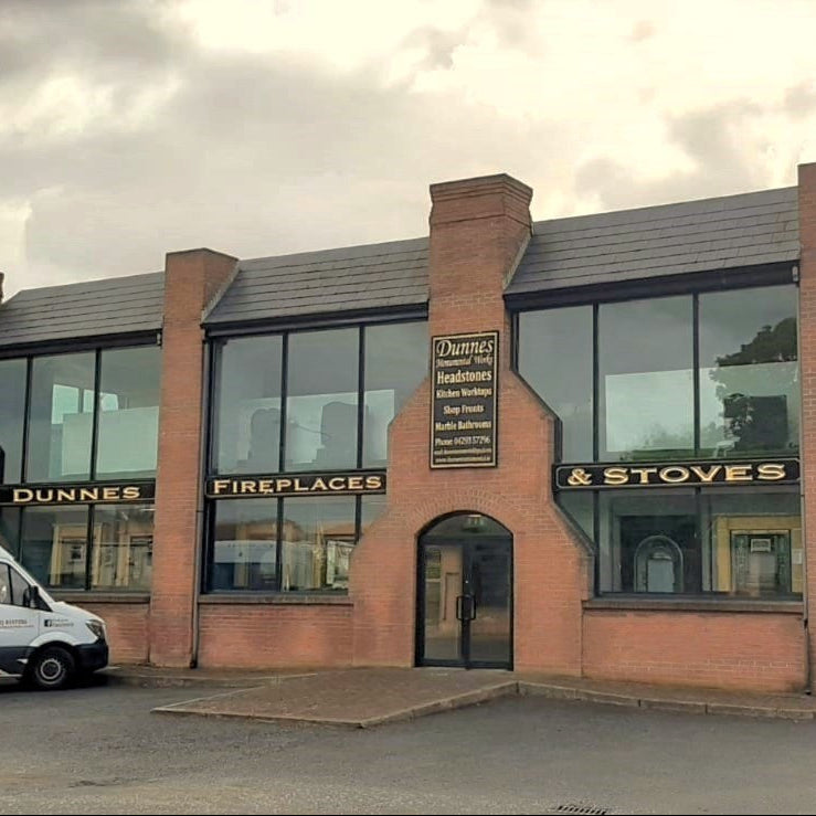 Commercial building with Dunnes Fireplaces & Stoves branding, including installation van outside
